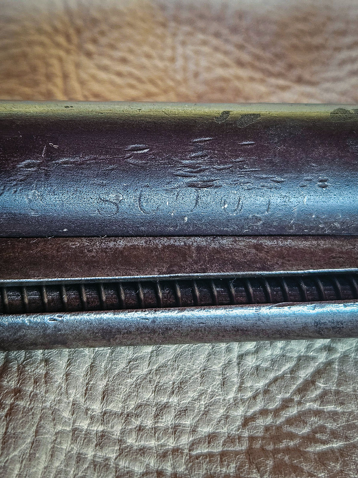 SCOUT can faintly be seen stamped on the belly of the barrel.